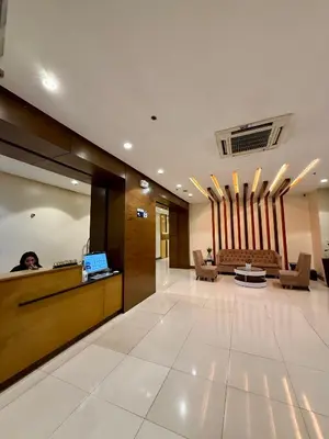 a lobby with a reception desk in a building at One Palmtree Villas in Manila