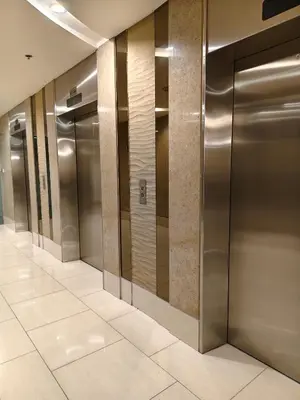 a row of elevator doors in a building at Shell residences Moa Staycation by jeric in Manila