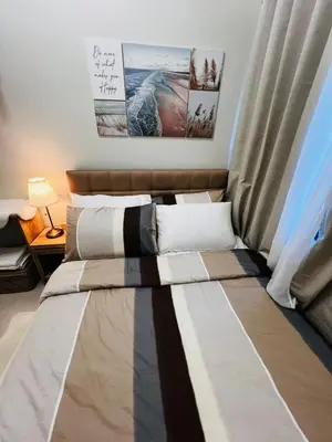 two beds sitting in a room with a window at MOA GRAND STAY Suite #01, Newly Turn-over Only! in Manila