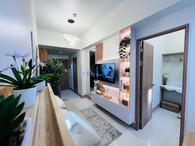 a living room with a door open to a room with plants at MOA GRAND STAY Suite #01, Newly Turn-over Only! in Manila