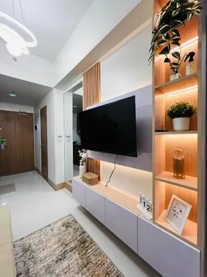 a living room with a flat screen tv on a wall at MOA GRAND STAY Suite #01, Newly Turn-over Only! in Manila