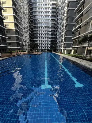 a large swimming pool with tall buildings in the background at MOA GRAND STAY Suite #01, Newly Turn-over Only! in Manila