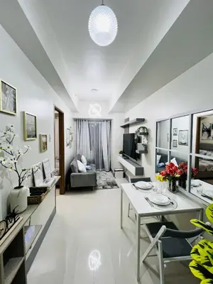 a living room with a table and a couch at MOA GRAND STAY Suite 02 Newly Turn-over Only in Manila