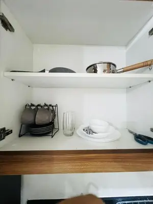 a kitchen shelf with plates and bowls on it at MOA GRAND STAY Suite 02 Newly Turn-over Only in Manila