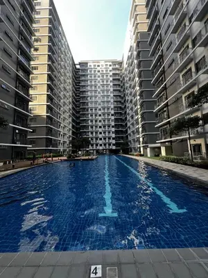 a large swimming pool with two tall buildings at MOA GRAND STAY Suite 02 Newly Turn-over Only in Manila