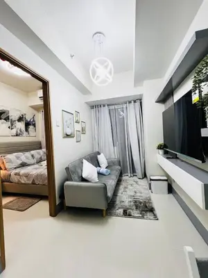 a living room with a couch and a television at MOA GRAND STAY Suite 02 Newly Turn-over Only in Manila