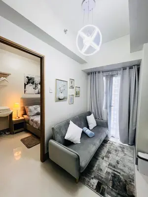 a living room with a couch and a mirror at MOA GRAND STAY Suite 02 Newly Turn-over Only in Manila