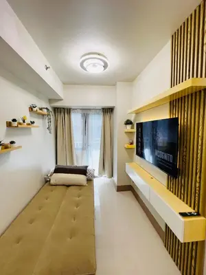 a living room with a flat screen tv on a wall at MOA GRAND STAY Suite 04 Newly Turn-over Only! in Manila