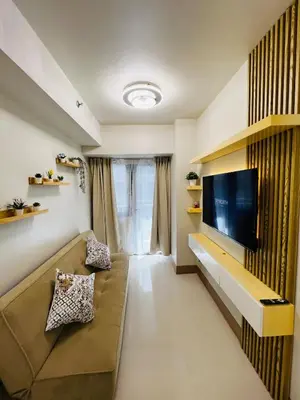 a living room with a couch and a flat screen tv at MOA GRAND STAY Suite 04 Newly Turn-over Only! in Manila