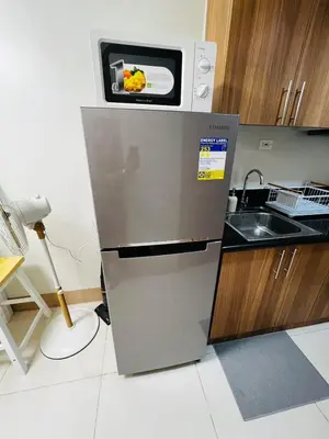 a microwave on top of a refrigerator in a kitchen at MOA GRAND STAY Suite 04 Newly Turn-over Only! in Manila