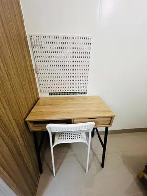 a wooden desk with a white chair next to a wall at MOA GRAND STAY Suite 03 Spacious Unit ! in Manila