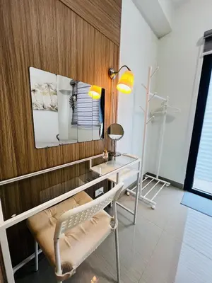 a room with a desk and a chair and a mirror at MOA GRAND STAY Suite 03 Spacious Unit ! in Manila