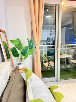 a room with a window with a potted plant at Staycation in Casitas in Manila