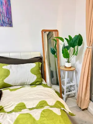 a bedroom with a bed and a mirror at Staycation in Casitas in Manila