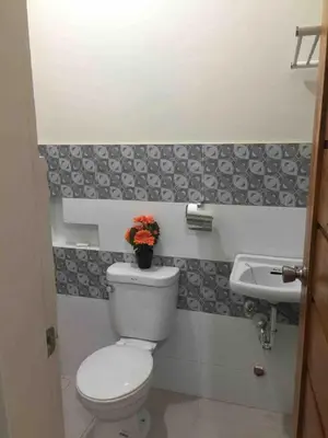 a bathroom with a toilet and a sink at Furnished 2BR Apartment in Paradahan