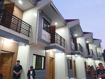a group of people standing in front of a house at Furnished 2BR Apartment in Paradahan