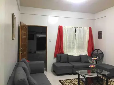 a living room with a couch and a table at Furnished 2BR Apartment in Paradahan