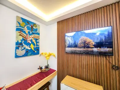 a living room with a television on a wooden wall at Serene City Abode in Santa Rosa
