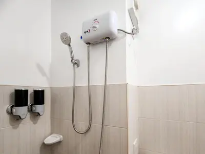 a bathroom with a shower with a blow dryer at Serene City Abode in Santa Rosa