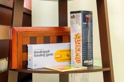 a wooden shelf with a box and a box bowling game at Serene City Abode in Santa Rosa