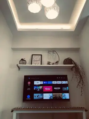 a tablet on a shelf in a room with two lights at Staycation in Bloom in Manila