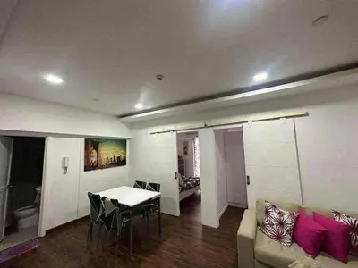 a living room with a couch and a table at Staycation in Casa Joaquin in Manila
