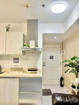 a kitchen with a counter and a white door at Staycation in Casa Joaquin in Manila