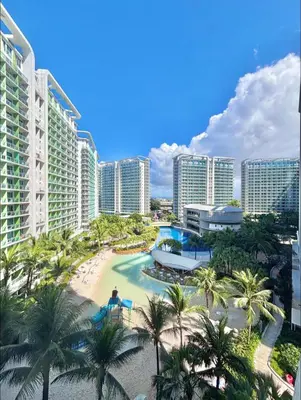 a view of a resort with palm trees and buildings at Staycation in Casa Joaquin in Manila