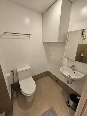 a bathroom with a toilet and a sink at Czech Theme in Manila
