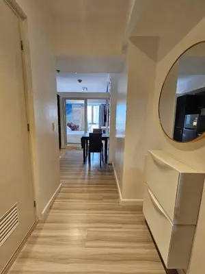 a dining room with a table and a mirror at Czech Theme in Manila