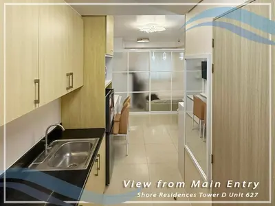 a kitchen with a sink and a view from main entry at GV Holiday Homes - Shore Residences MOA - Cozy 1BR Apartment in Manila