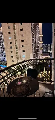 a balcony with a table and chairs and buildings at Solemare parksuites tower C in Manila