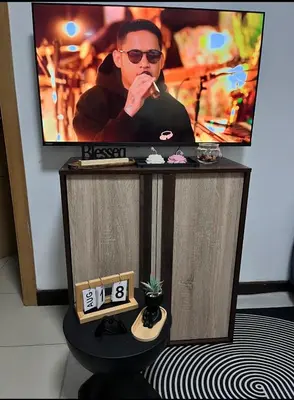 a tv screen with a man on top of a table at Solemare parksuites tower C in Manila