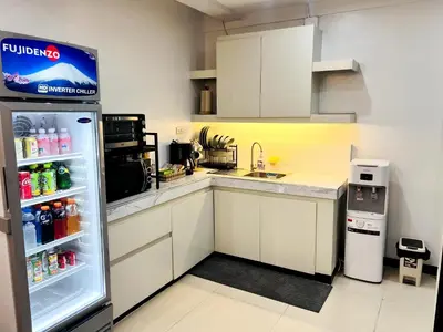 a kitchen with an open refrigerator with drinks in it at Layover at 1146 in Manila