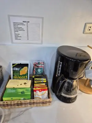 a coffee maker sitting on top of a counter next to a basket at Layover at 1146 in Manila
