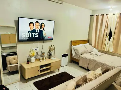 a bedroom with a bed and a tv on the wall at Hirayuna Space in Santa Rosa