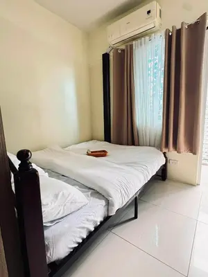 a small bed in a room with a window at The Metro Breeze - Staycation in Manila