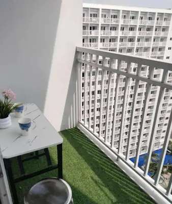 a balcony with a table and a building at Shorestandrelax in Manila