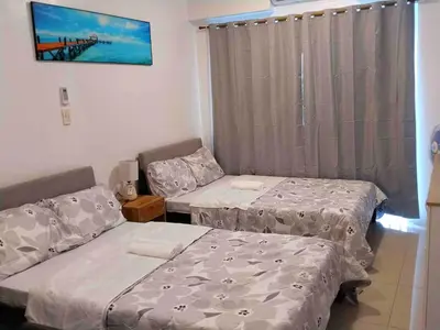 a room with two beds and a window at Shorestandrelax in Manila