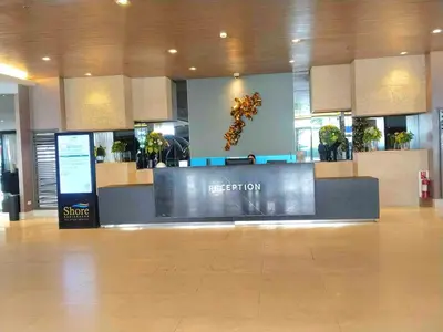 a reception desk in a mall with a sign on it at Shorestandrelax in Manila