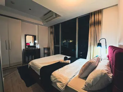 a bedroom with a bed with a large window at Celestial Shores Staycation at Azure Resort in Manila