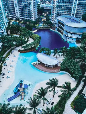 a resort with a pool and a water slide at Celestial Shores Staycation at Azure Resort in Manila