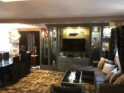 a living room with a couch and a television at Our home is your castle in Caong