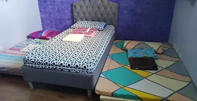 a bedroom with a bed with a colorful bedspread at Our home is your castle in Caong