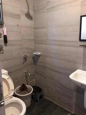 a bathroom with a toilet and a sink at Our home is your castle in Caong