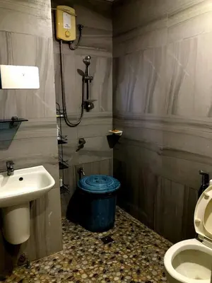 a bathroom with a toilet and a sink at Our home is your castle in Caong