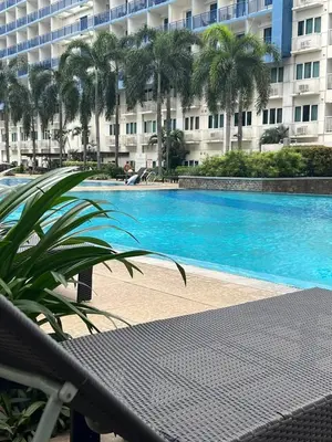 a large swimming pool in front of a large building at Sea Residence - 2 Bedrooms - 5 mins walk to MOA 1A in Manila