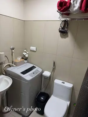 a small bathroom with a toilet and a sink at Juvrey Studio-Unit Breeze Residences in Manila