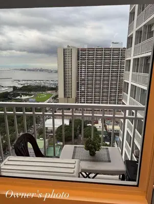 a balcony with a table and a view of the ocean at Juvrey Studio-Unit Breeze Residences in Manila