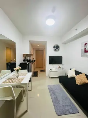 a living room with a couch and a table at Allie's Cozy Place in Manila